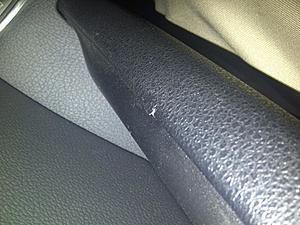 Should a rip in armrest of the door panel be under warranty?-img-20121024-00038.jpg