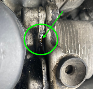 Engine oil pooling between filter cap and oil cooler-leak.png