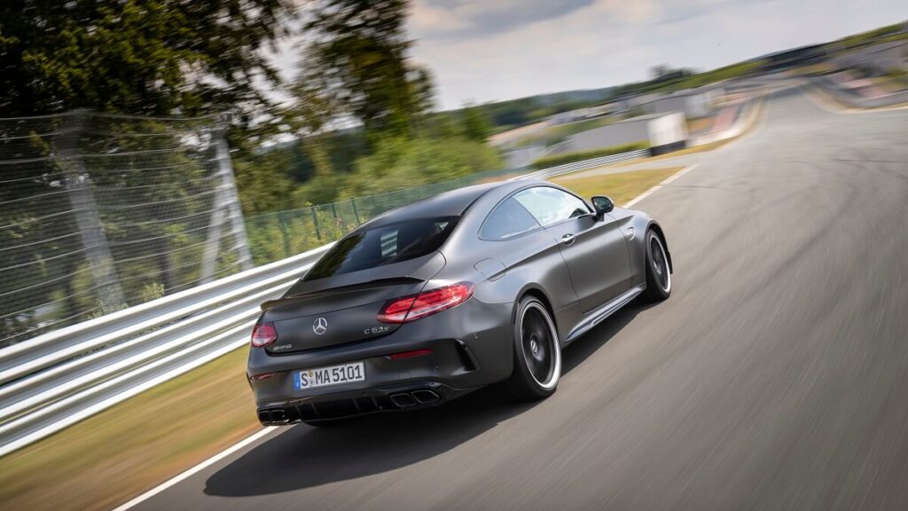 A C63 S Coupe blasts around a track. 