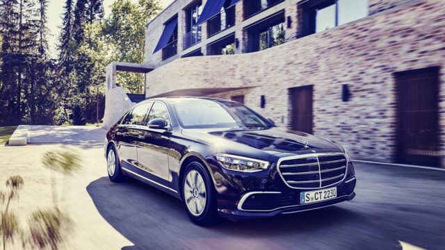 The armored Mercedes-Benz S 680 GUARD 4MATIC parked beside a brick building